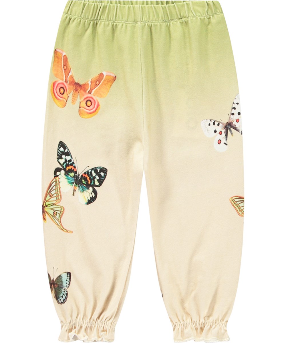 Selena - Papillon Pants - Gebrokken witte en groene joggingbroek van biologisch katoen met een kleurrijke vlinderprint.