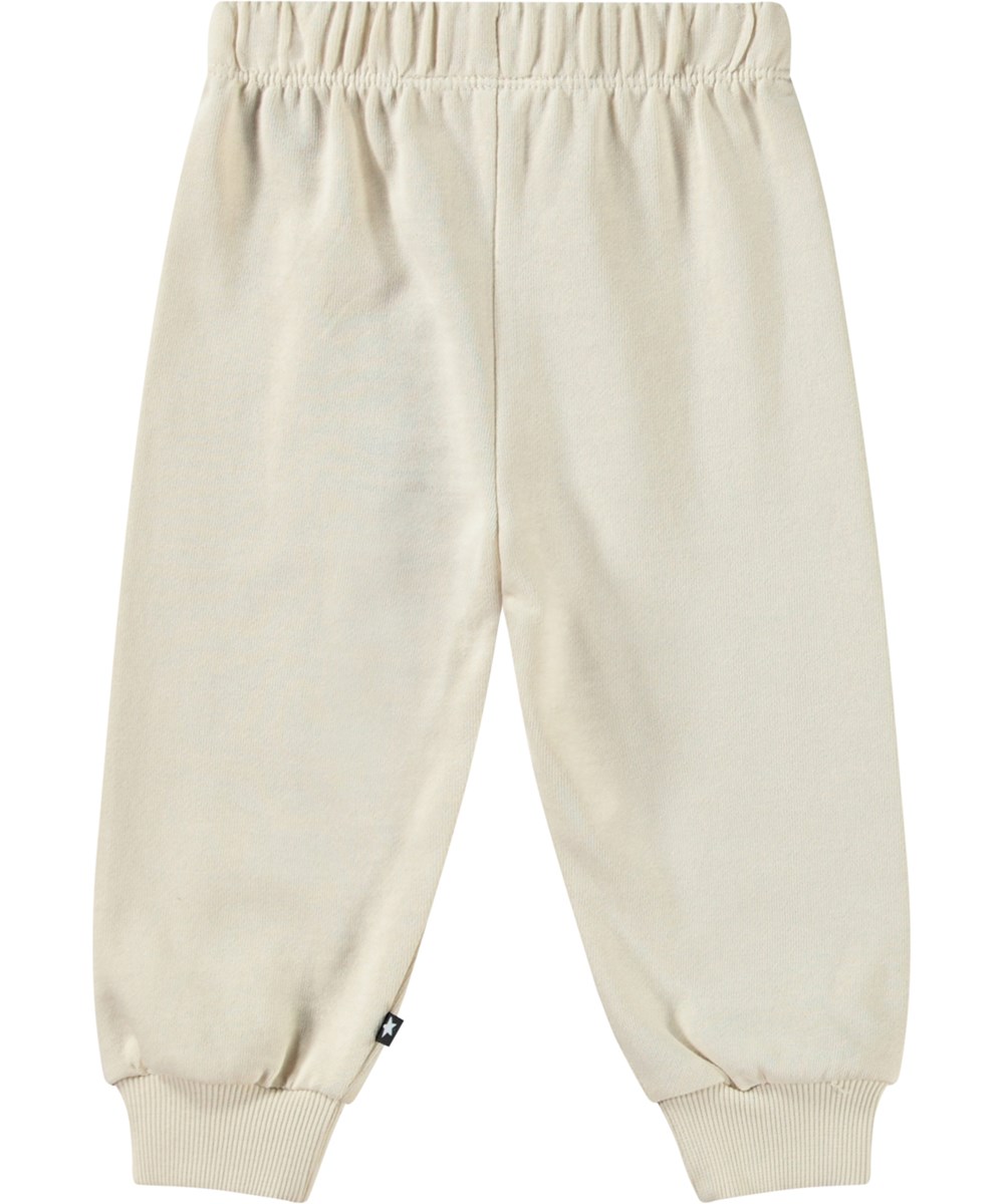 Simeon - Jungle Heart - Beige joggingbroek voor baby's van zacht biologisch katoen met lachende hartjes.