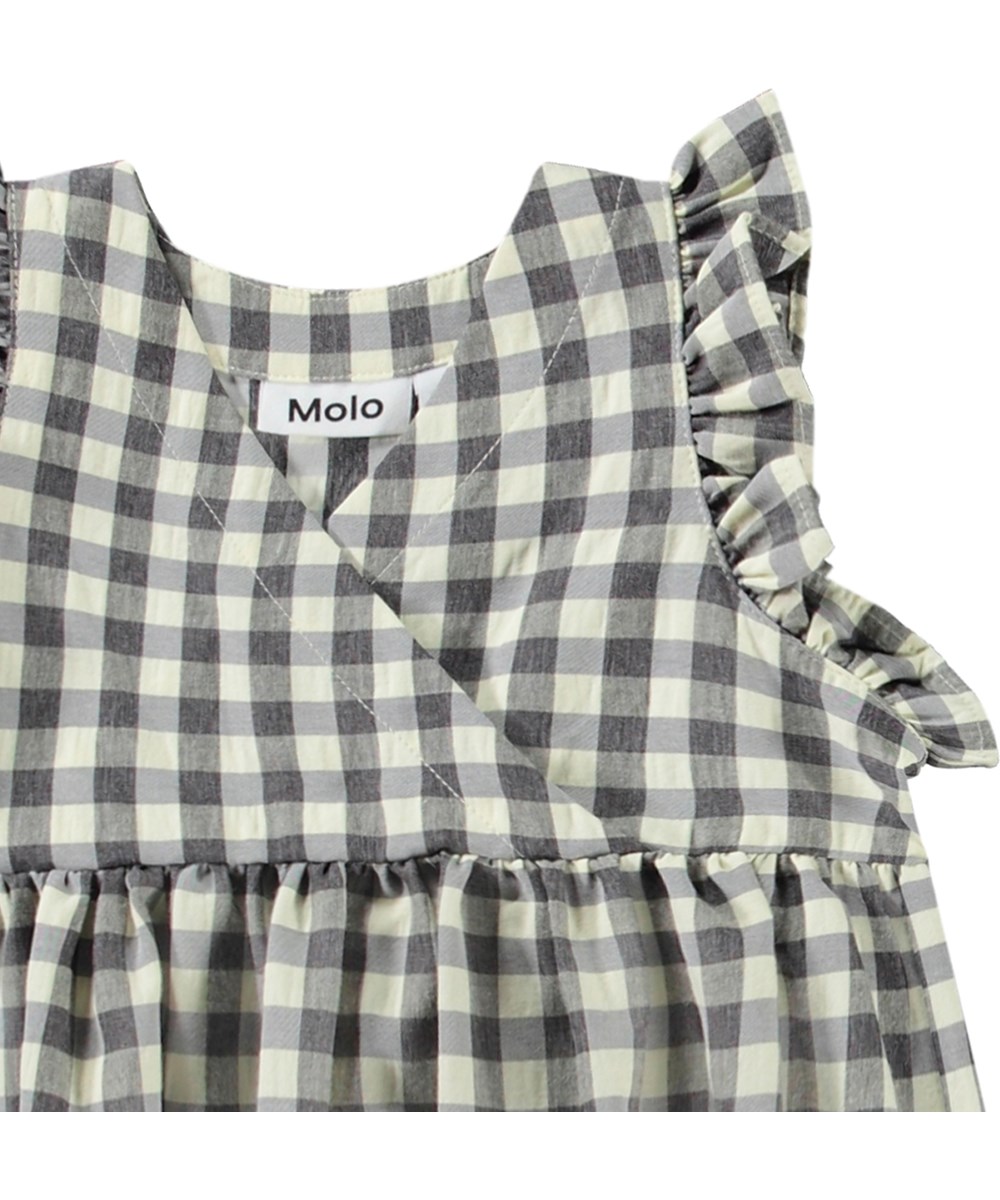 Callie - Sun Check - Zwart wit geblokte babyjurk van biologisch katoen met schattige details.