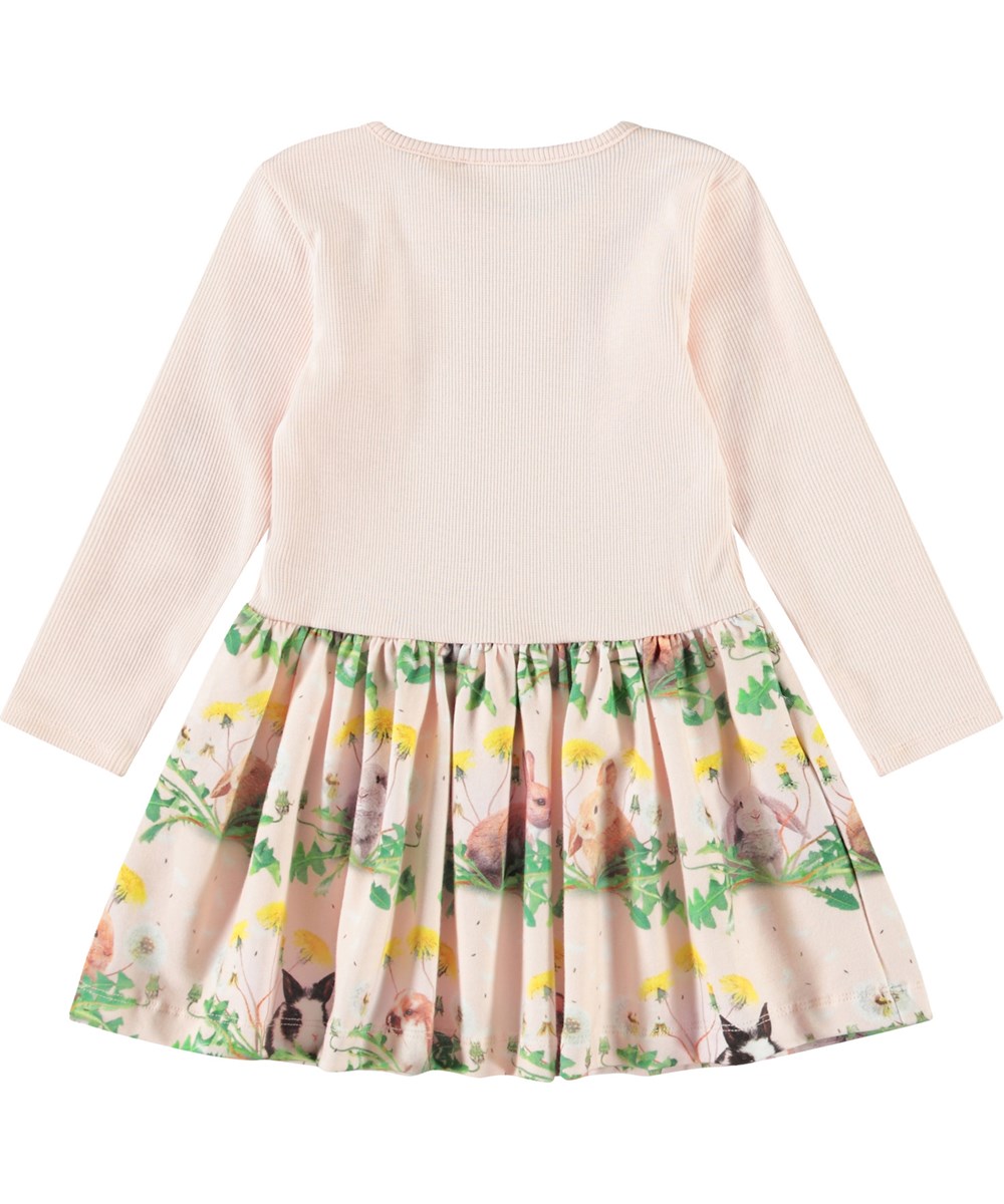 Carel - Bunnies United - Babyjurk van biologisch katoen met lange mouwen. De jurk is roze met een print van konijntjes en paardenbloemen.