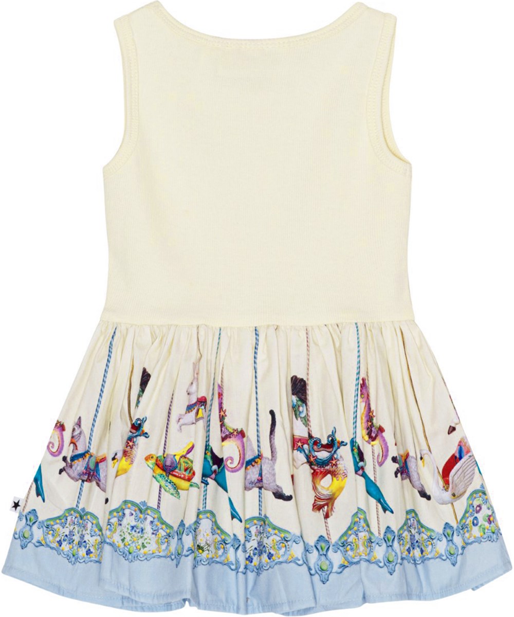 Cordelia - Sea Carousel - Crèmekleurige biologische babyjurkje met draaimolenprint