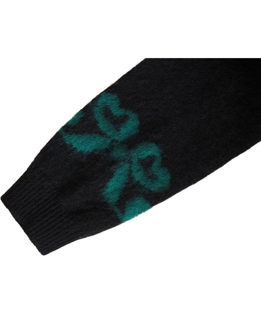 Gilby - Fancy Bows - Gebreide wollen trui voor de kleintjes. De trui is zwart met kleurrijke geweven strikken aan de voor- en achterkant.