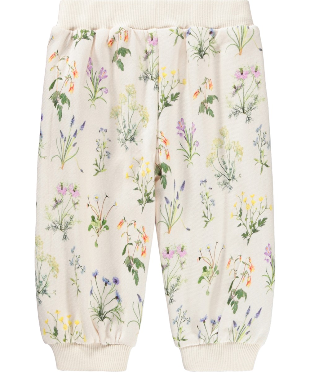 Sallie - Primavera - Hvide babybukser i økologisk bomuld med blomsterprint og flæser