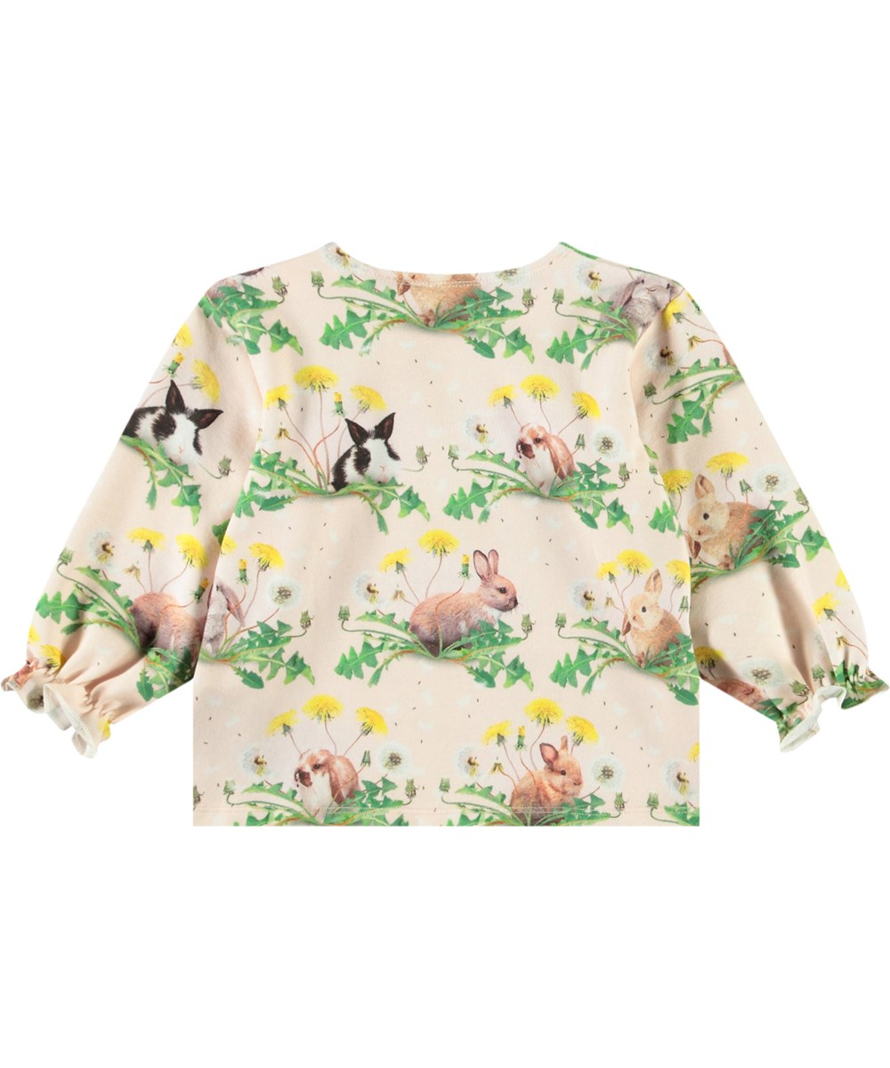 Elina - Bunnies United - Langærmet bluse i økologisk bomuld til baby. Blusen er lyserød med et print af kaniner og mælkebøtter.