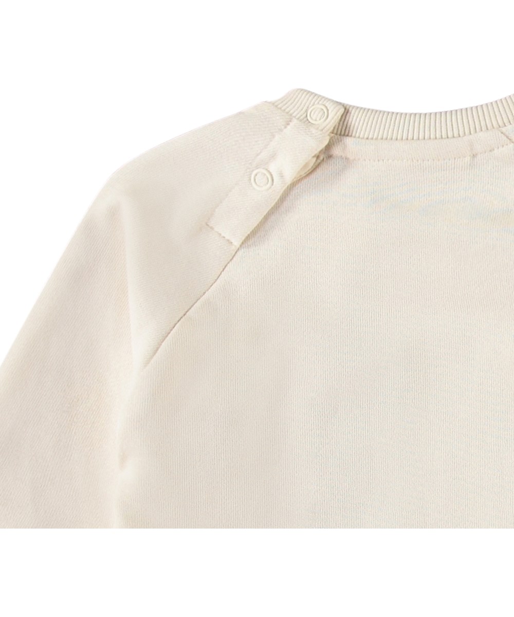 Disc - Jungle Heart - Økologisk cremefarvet babysweatshirt med grønt smilende hjerte