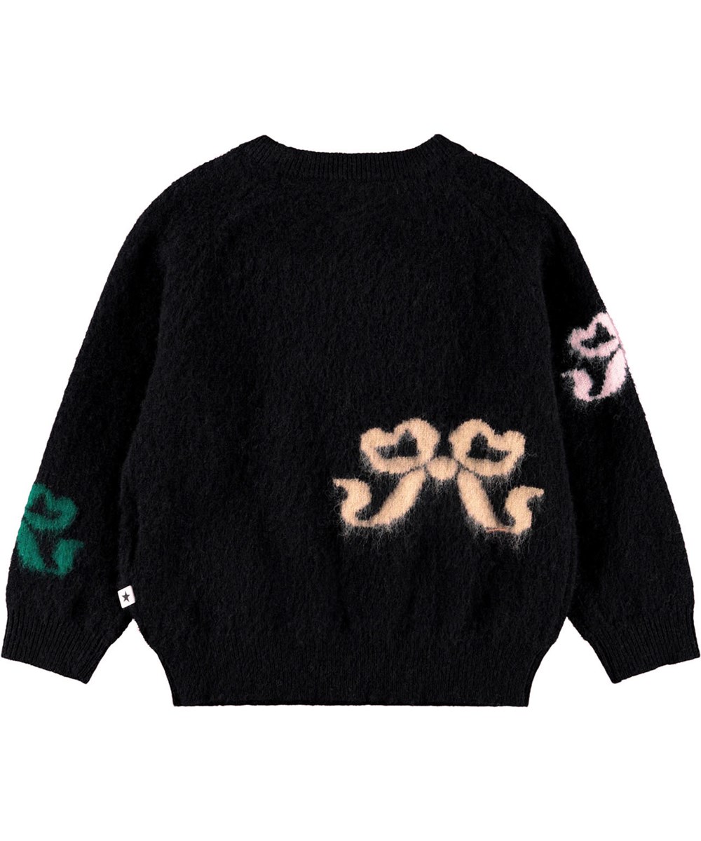 Gilby - Fancy Bows - Striktrøje i uld til baby. Trøjen er sort med multifarvede vævede sløjfer på front og bag.