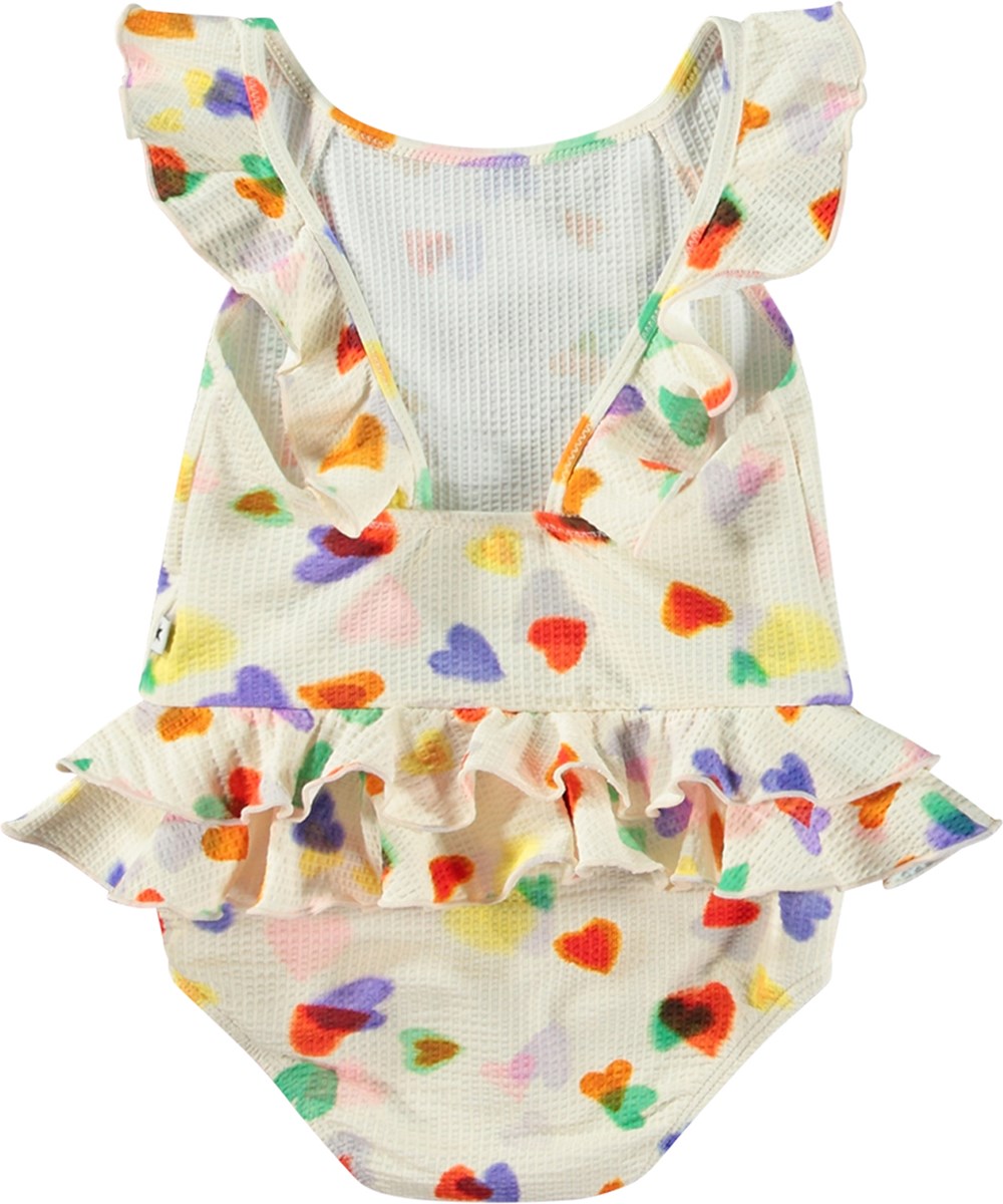 Nalani - Rainbow Hearts - Weißer Baby-Badeanzug aus recyceltem Polyester mit UV-Schutz 50+.