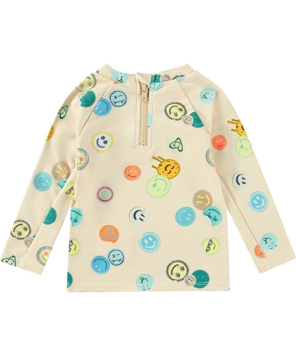Nemo - Sand Smile - Beiger Baby-Rashguard aus recyceltem Polyester mit UV-Schutz 50+.