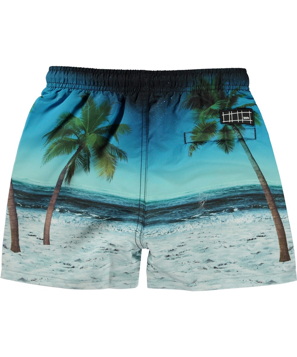 Niko - Sunset Surfer - Blaue Badeshorts mit kurzen Beinen und Placement-Surfbrett-Print