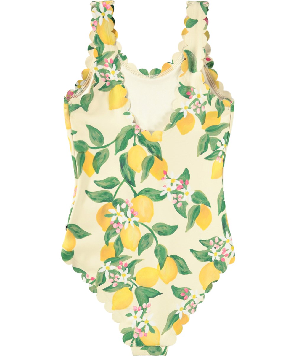 Noelle - Citrus - Gelber Badeanzug mit Wellenkanten und Zitrusdruck für Kinder aus recyceltem Polyester mit UV-Schutz 50+.