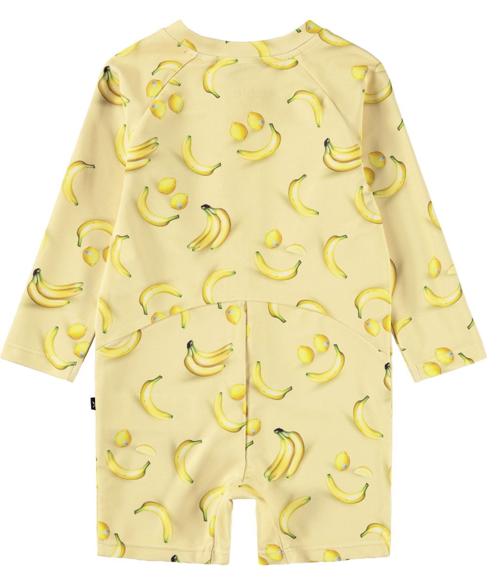 Neka LS - Lemon Banana - Gul badedragt med frugtprint til baby og børn med lange ærmer og korte ben i genanvendt polyester og UV-beskyttelse 50+.