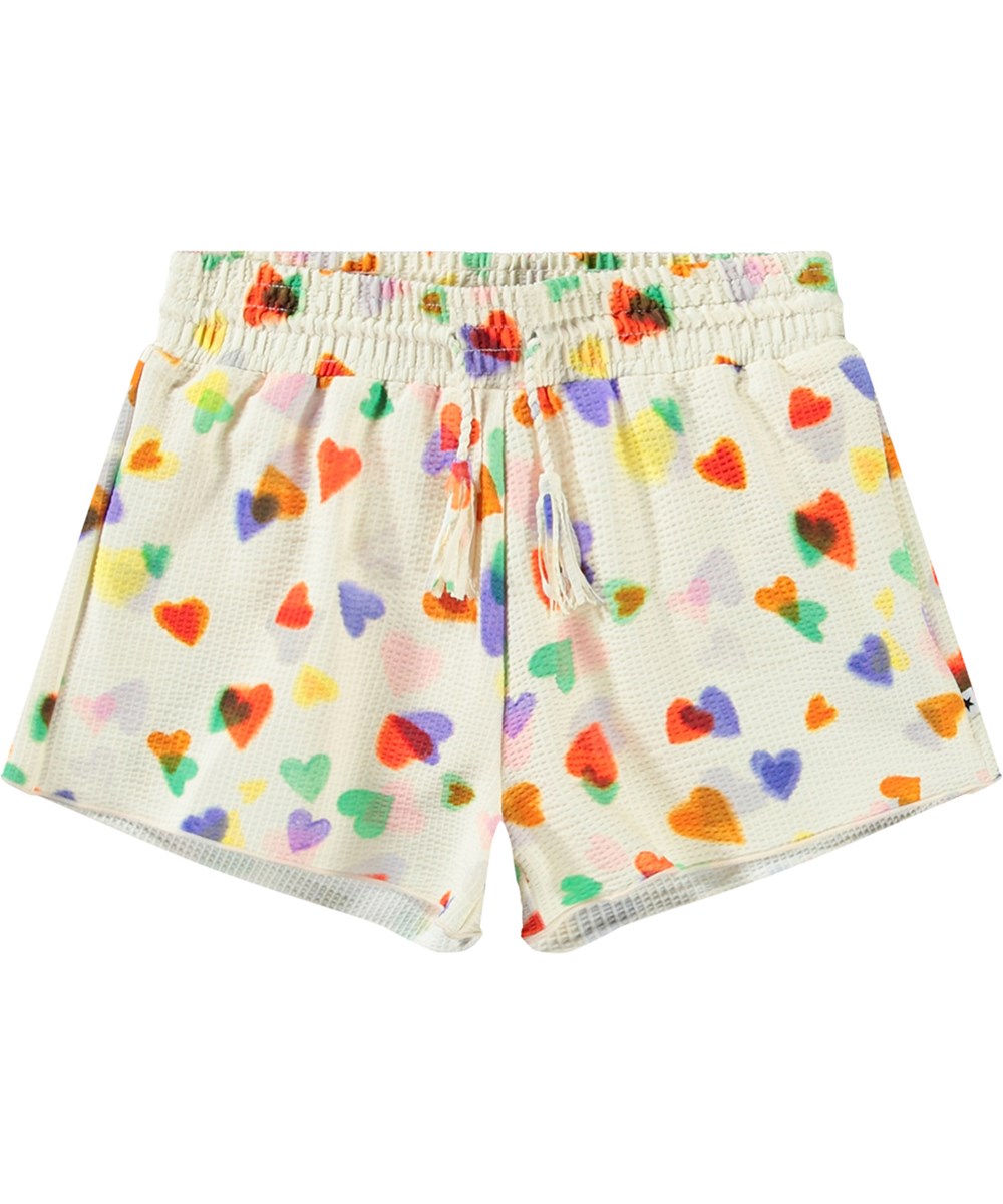 Nicci - Rainbow Hearts - Hvide badeshorts til aktive børn med UV-beskyttelse 50+ og et farverigt hjerte print