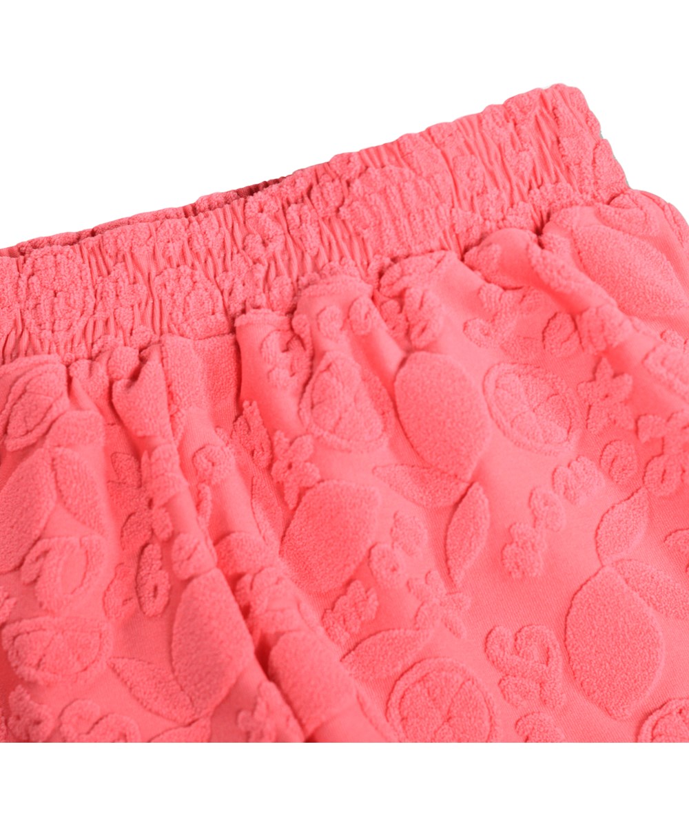 Nicci Terry - Lemon Quotes - Pink badeshorts med citrusmønster og UV-beskyttelse 50+.