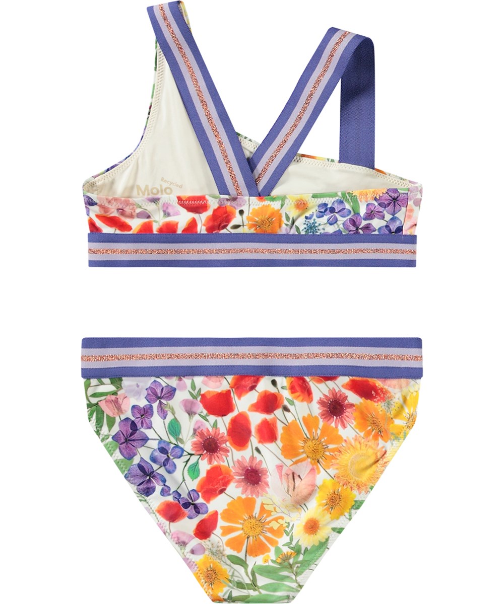 Nicola - Flowerpress - Asymmetrisk sporty bikini til aktive børn fremstillet i genanvendt polyester med UV-beskyttelse 50+