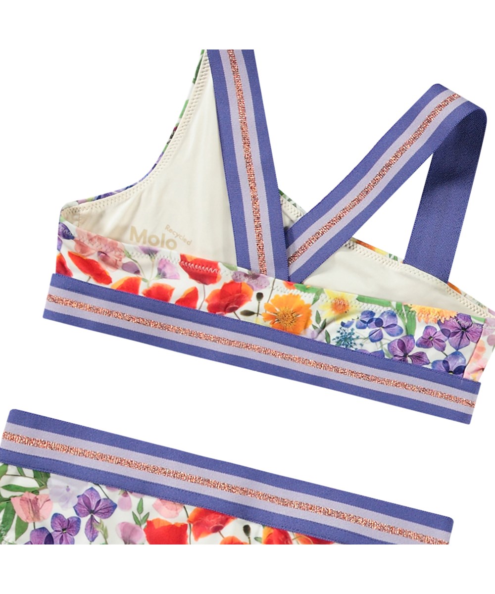 Nicola - Flowerpress - Asymmetrisk sporty bikini til aktive børn fremstillet i genanvendt polyester med UV-beskyttelse 50+