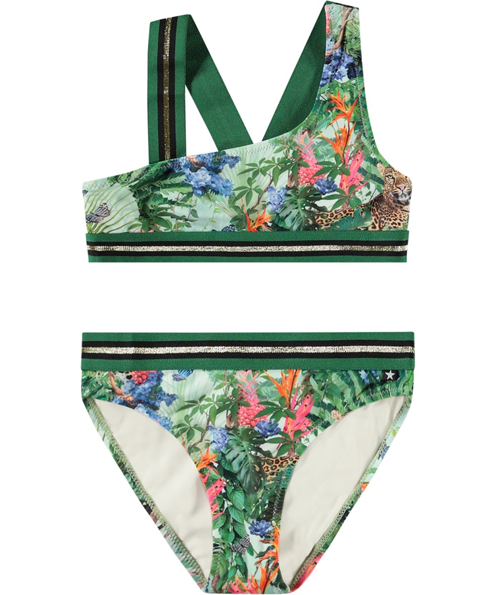 Nicola - Green Tropical - Asymmetrisk sporty bikini til aktive børn fremstillet i genanvendt polyester med UV-beskyttelse 50+
