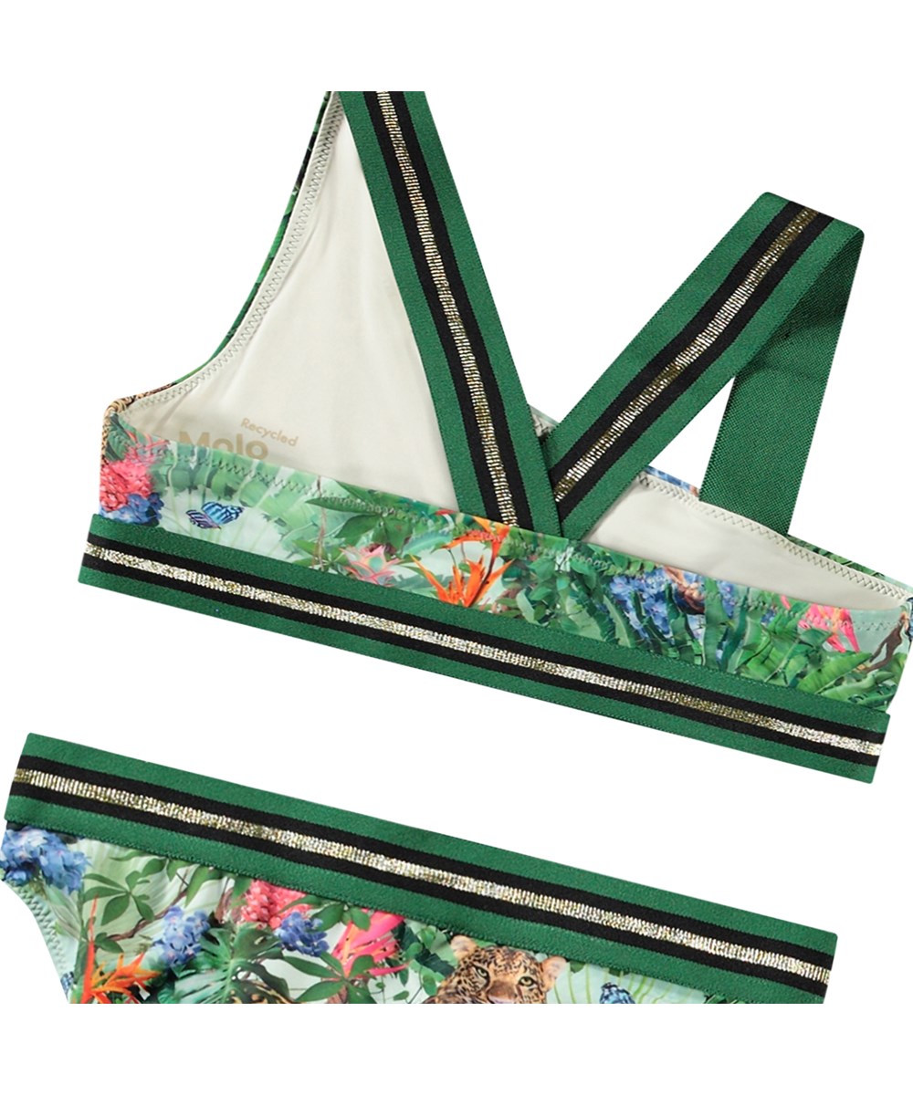 Nicola - Green Tropical - Asymmetrisk sporty bikini til aktive børn fremstillet i genanvendt polyester med UV-beskyttelse 50+