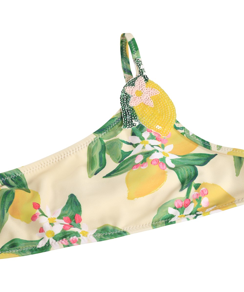 Naja - Citrus - Gul, asymmetrisk bikini för barn med citrusmönster i återvunnen polyester med UV-skydd 50+.