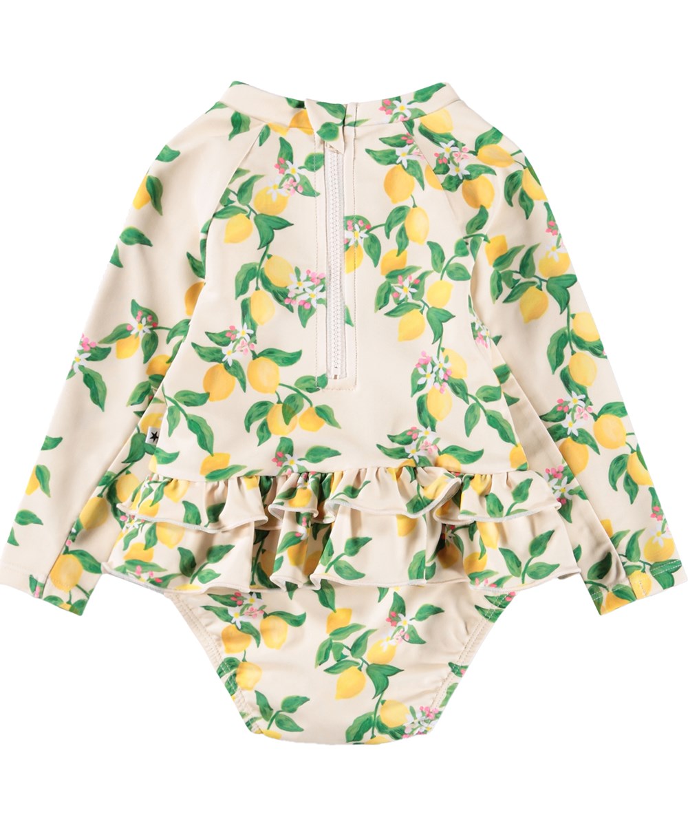 Narice - Mini Citrus - Gul, långärmad baddräkt för bebis med citrusmönster i återvunnen polyester med UV-skydd 50+.