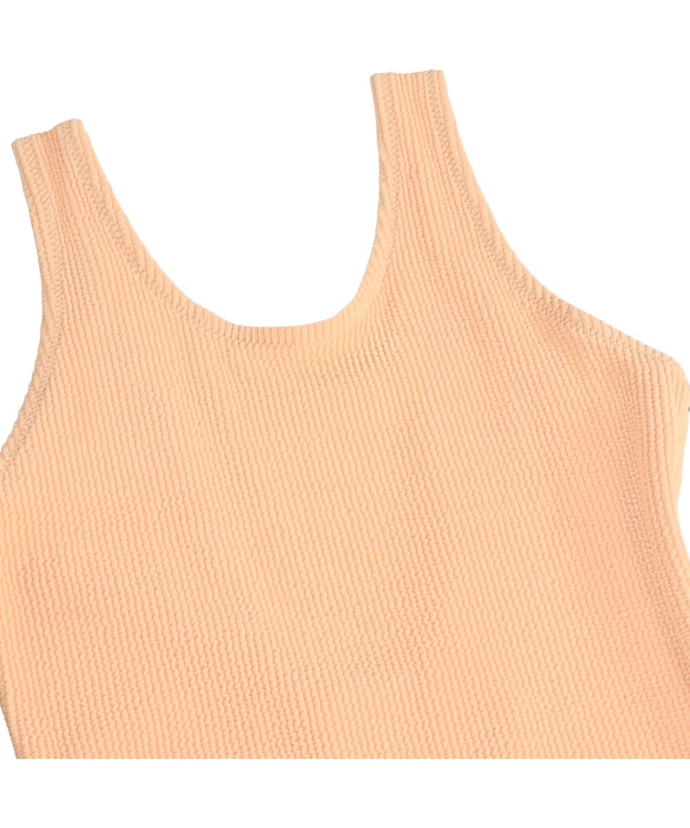 Nika Crepe - Peach Fuzz - Orange stretchig crepe-baddräkt för barn med UV-skydd 50+.