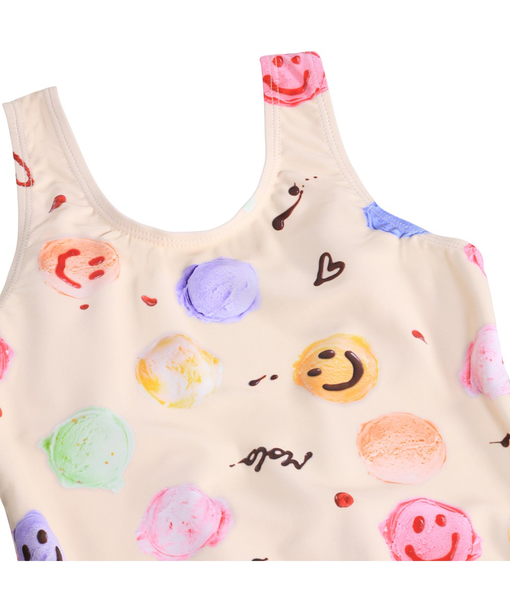 Nika - Smile Scoops - Gräddfärgad baddräkt med glassmönster för barn i återvunnen polyester med UV-skydd 50+.