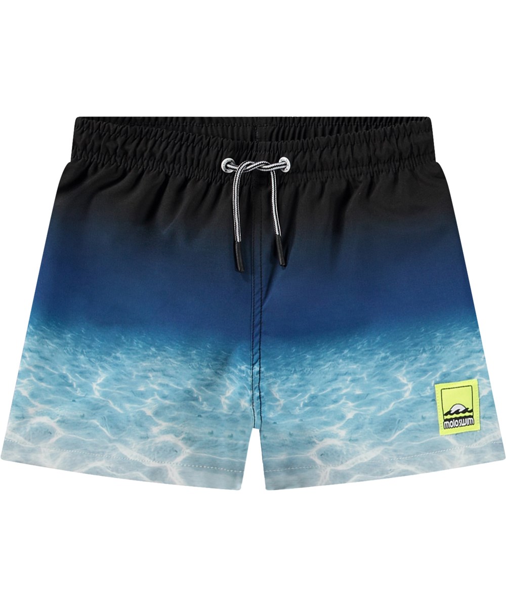 Niko - Faded Ocean - Sportiga svarta och blå badshorts för aktiva barn i återvunnen polyester med UV-skydd 50+.