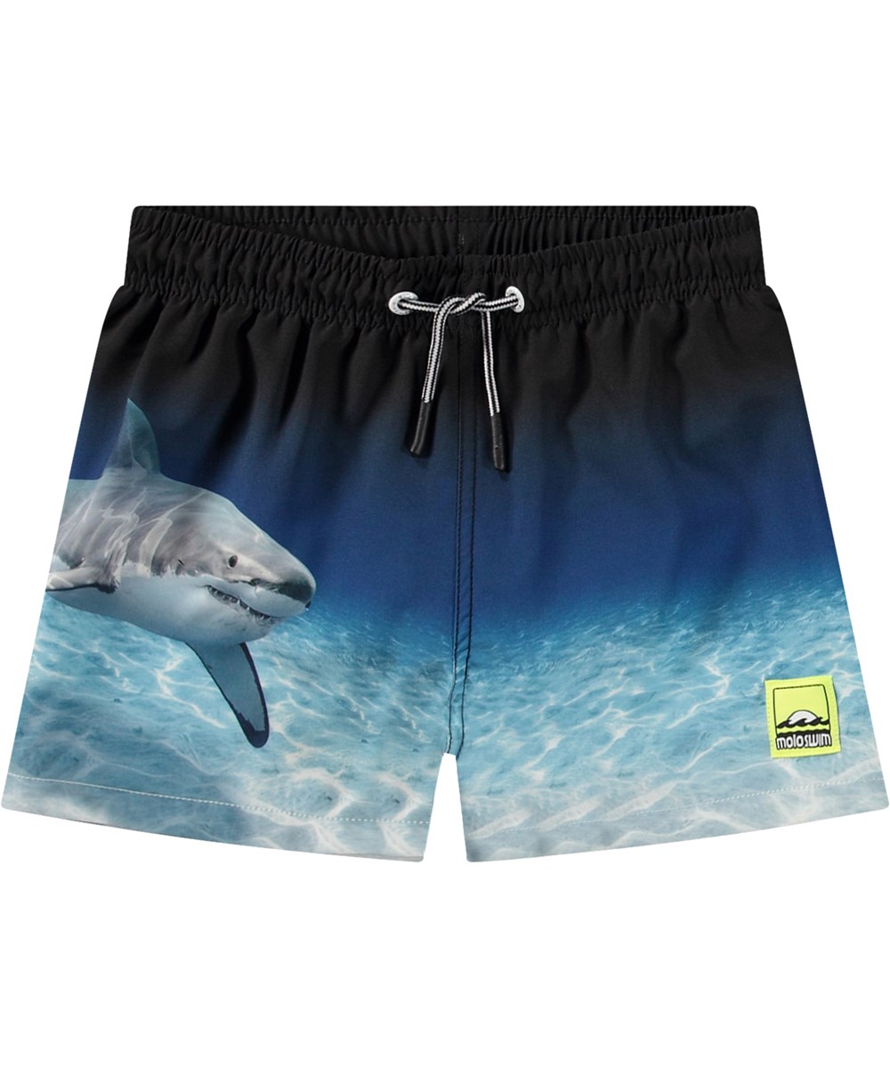 Niko - Faded Shark - Sportiga svarta och blå badshorts för aktiva barn i återvunnen polyester med UV-skydd 50+.
