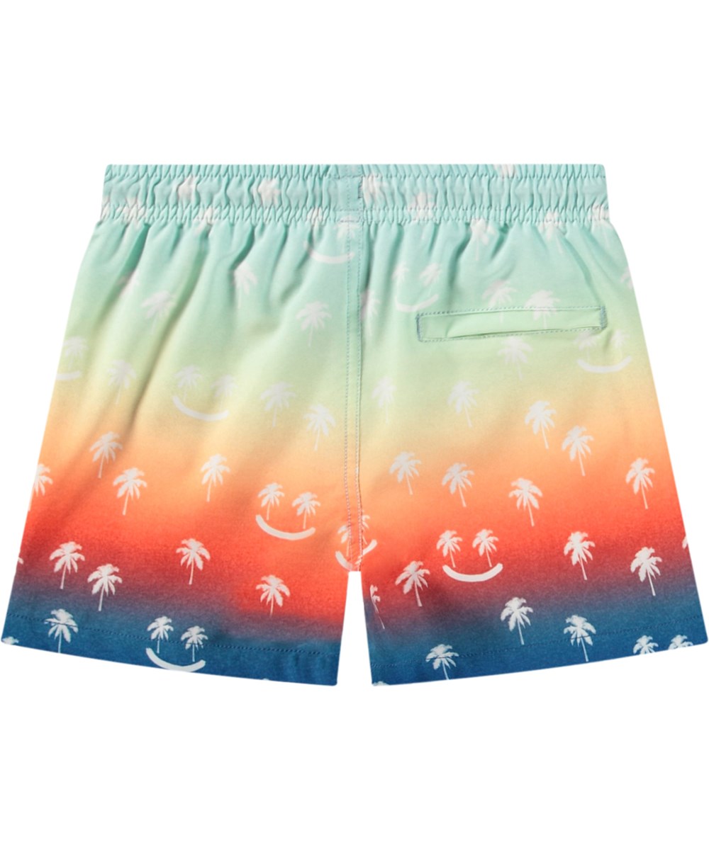 Niko - Palmtree Smile - Regnbågsfärgade sportiga badshorts för aktiva barn i återvunnen polyester med UV-skydd 50+.