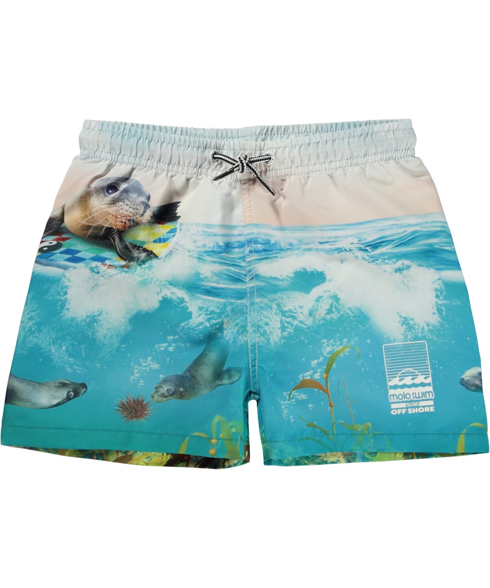 Niko - Sealion - Blå badshorts med korta ben och en surfande säl. 