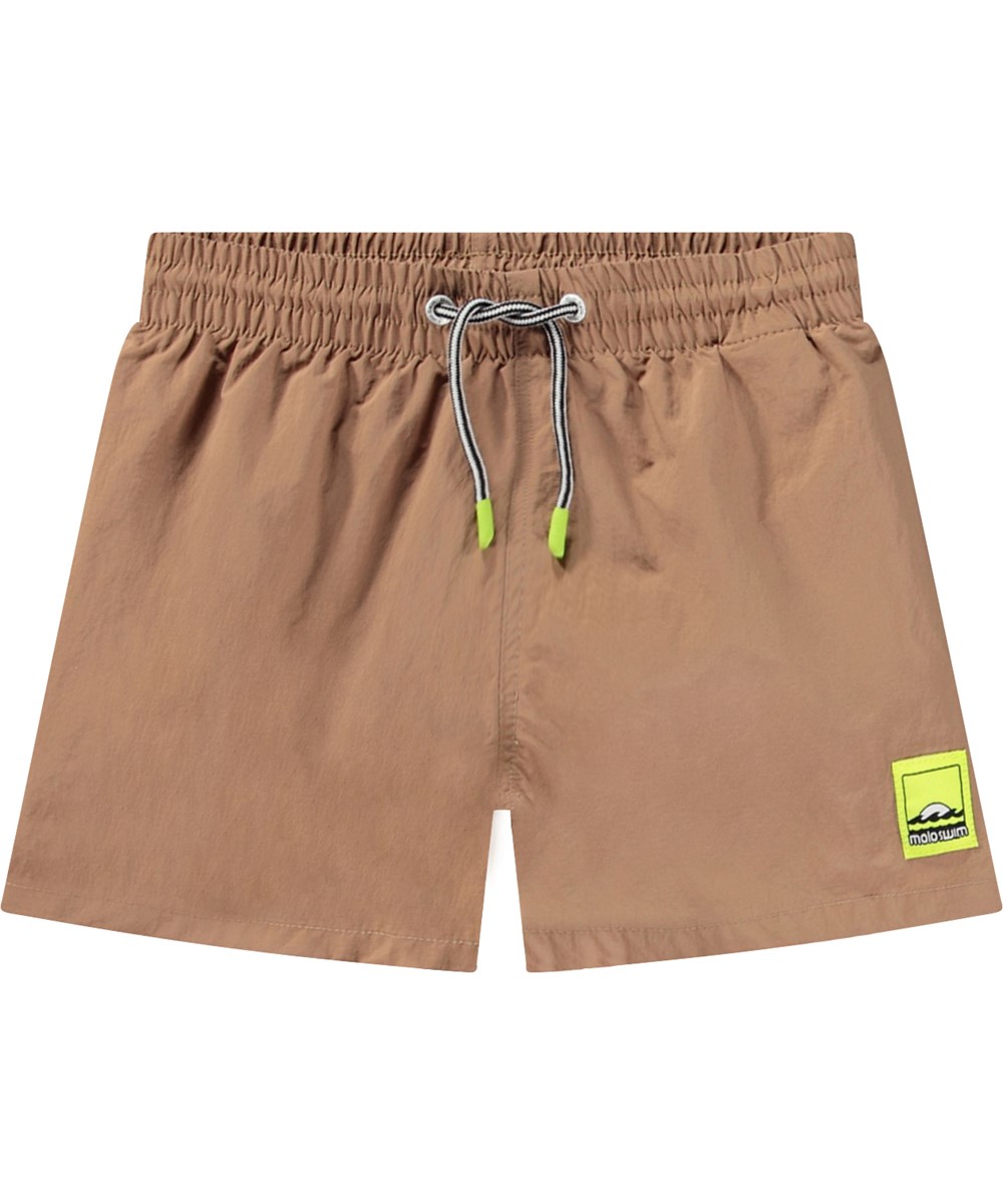 Niko Solid - Sandalwood - Sportiga beige badshorts för aktiva barn i återvunnen nylon med UV-skydd 50+.