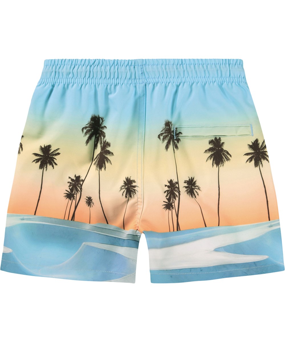 Niko - Sunrise Skate - Sportiga badshorts i blått och orange med ett skatemönster för aktiva barn i återvunnen polyester med UV-skydd 50+.