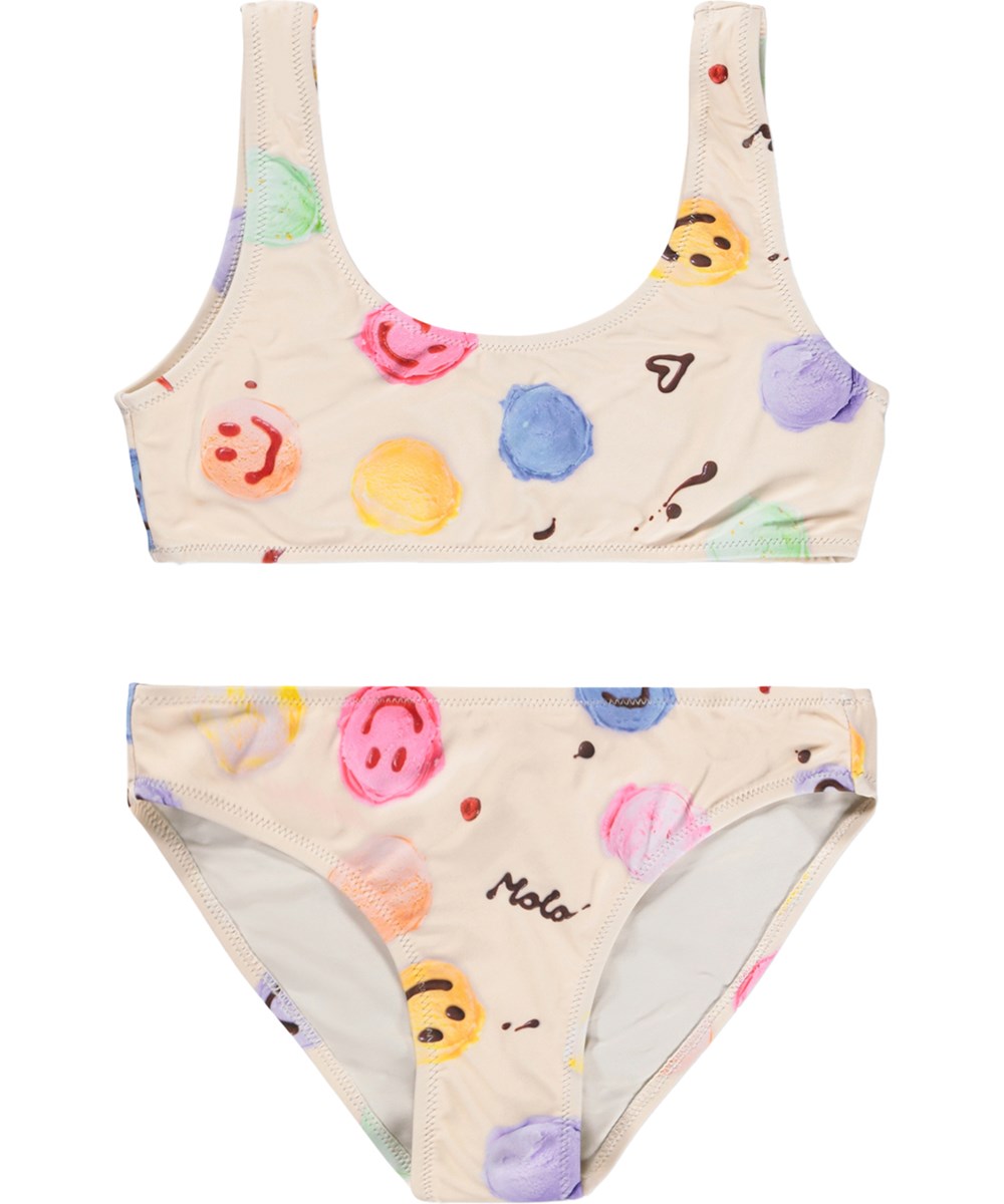 Nola - Smile Scoops - Krämfärgad stretchig bikini för barn med glassmönster i återvunnen polyester med UV-skydd 50+.