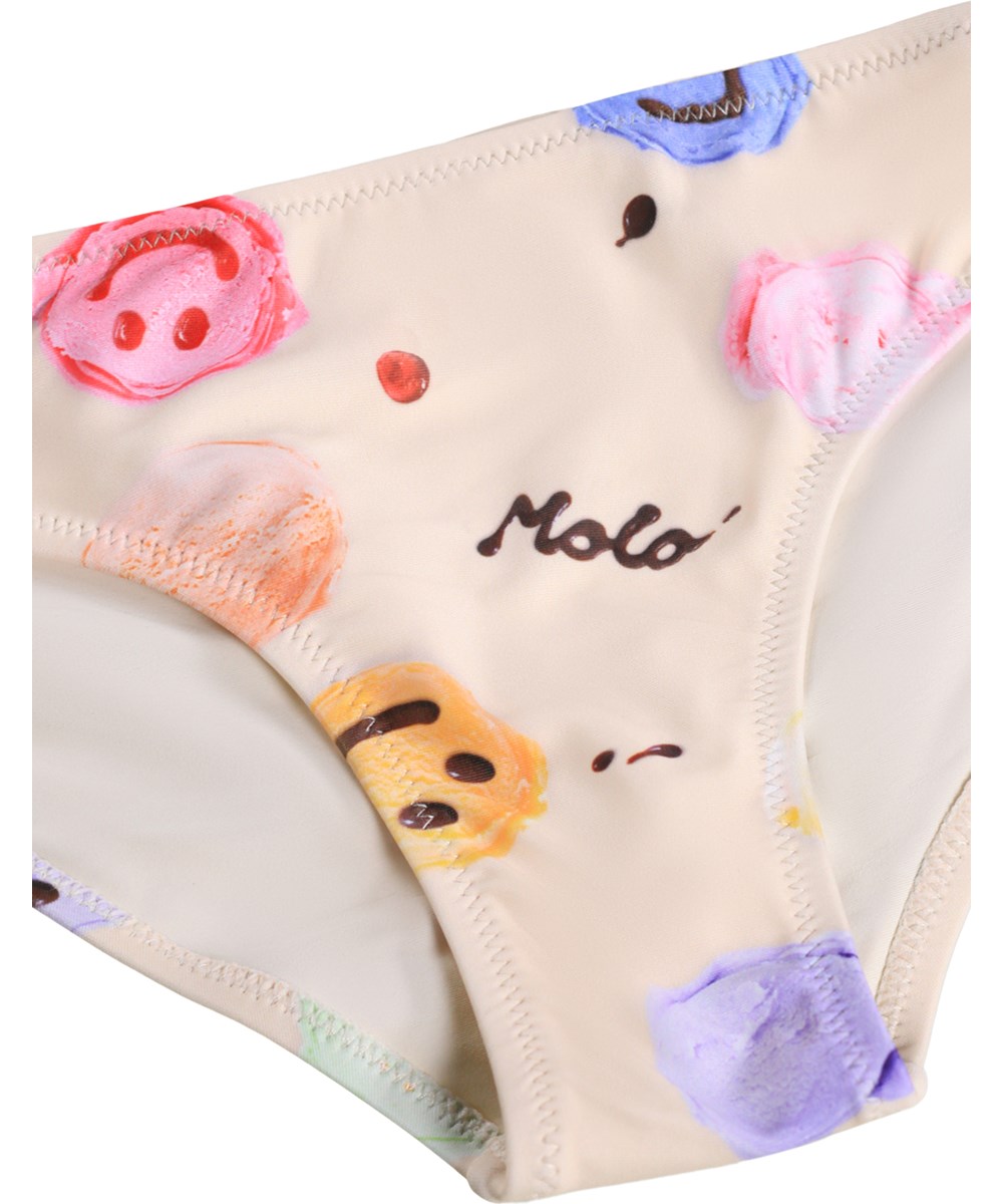 Nola - Smile Scoops - Krämfärgad stretchig bikini för barn med glassmönster i återvunnen polyester med UV-skydd 50+.