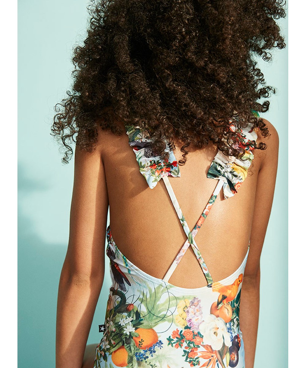 Nitika - Tropical Art - Lichtblauwe badpak met een print van tropische vogels en bloemen