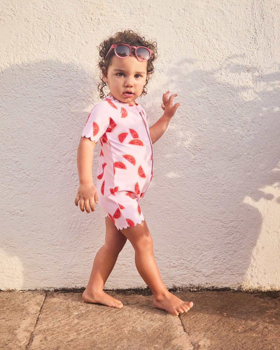 Nolu - Melon Pink - Roze badpak met korte mouwen en pijpen van gerecycled polyester en UV-bescherming 50+ gemaakt voor kinderen.