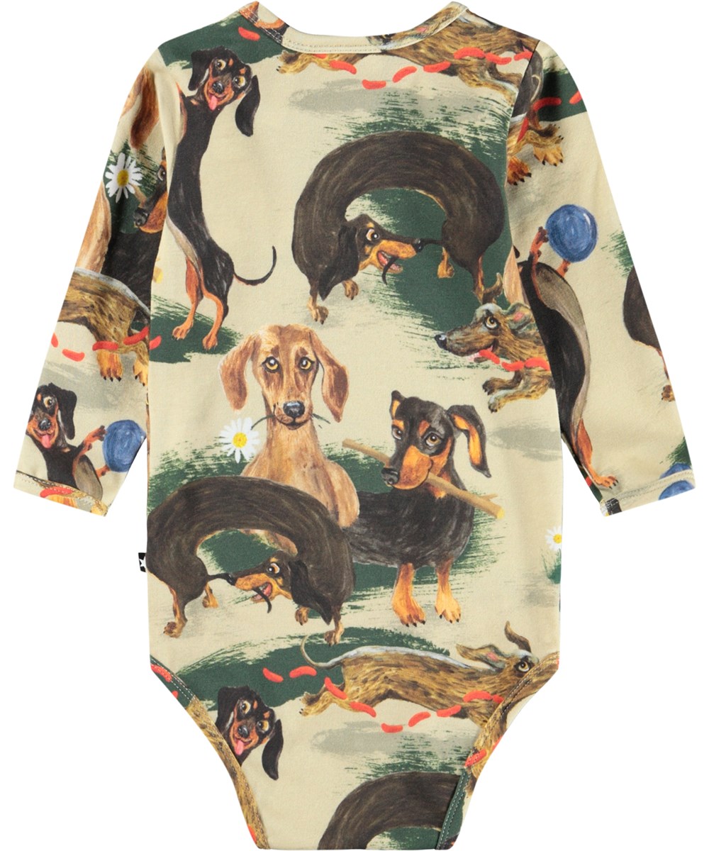 Foss - Painted Dogs - Beige långärmad body i ekologisk bomull för baby med taxar.