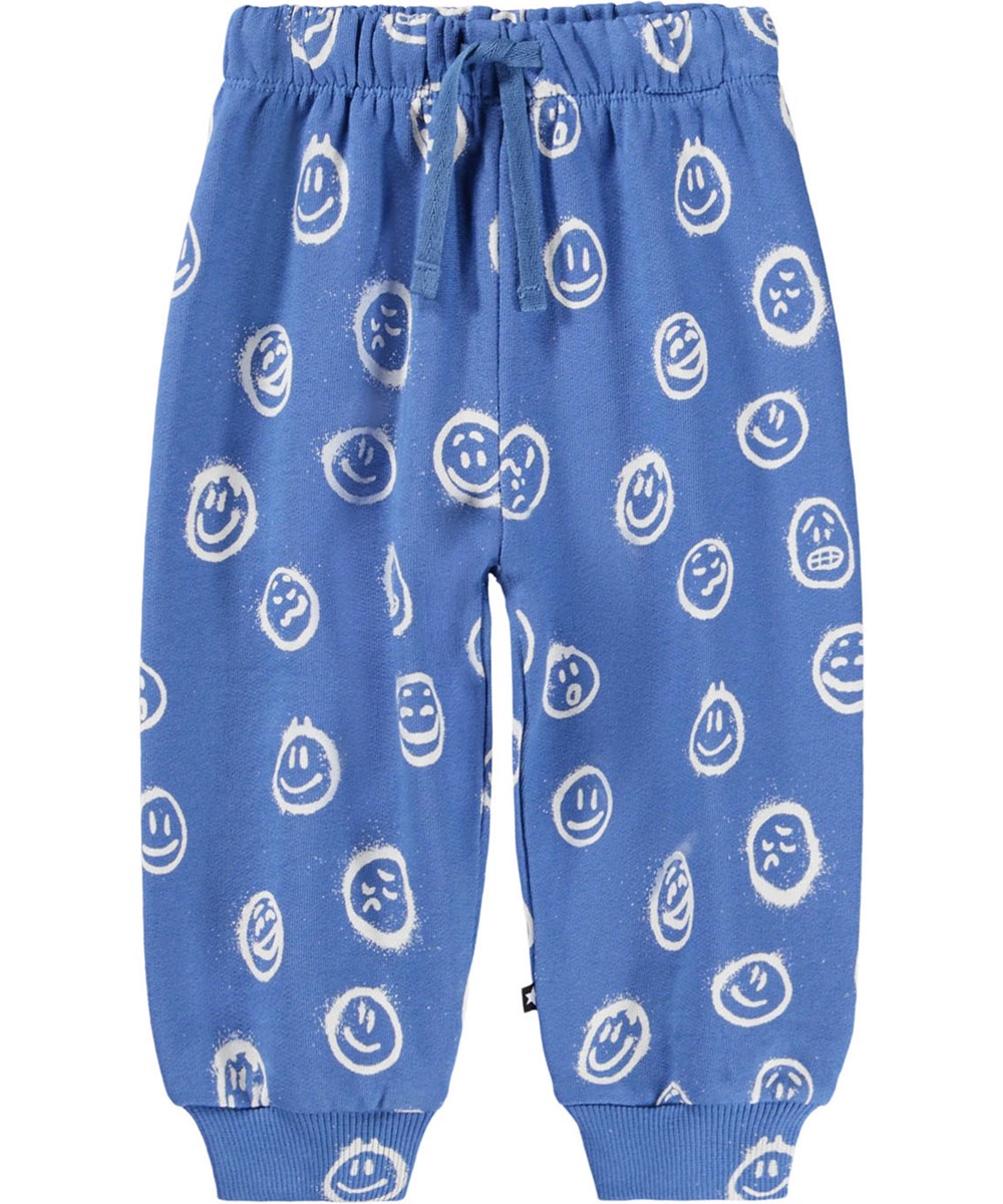 Simeon - Blue Moods - Mjuka blå byxor för baby i ekologisk bomull med vita ansikten i olika humör.