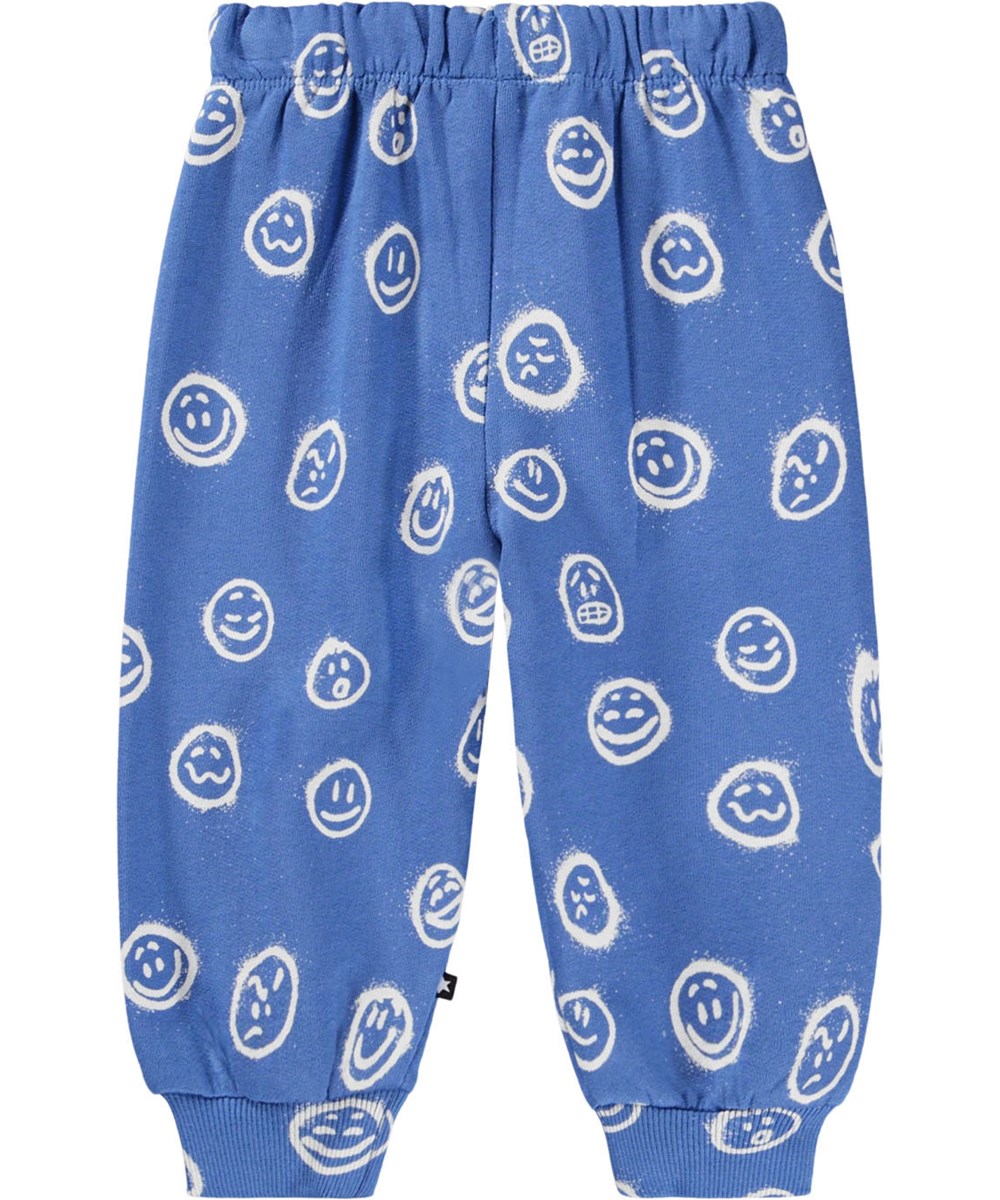 Simeon - Blue Moods - Mjuka blå byxor för baby i ekologisk bomull med vita ansikten i olika humör.