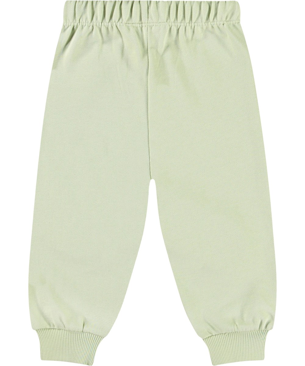 Simeon - Misty Green - Mjuka byxor i ekologisk bomull för baby. Byxorna är ljusgröna med mjuka smileys.