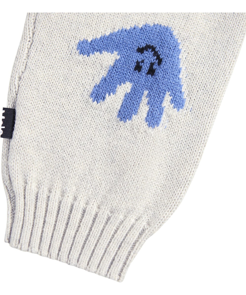 Sol - Happy Hands - Beige byxor för de minsta i en mjuk ribbstickad bomulls- och ullblandning med en leende hand framtill.