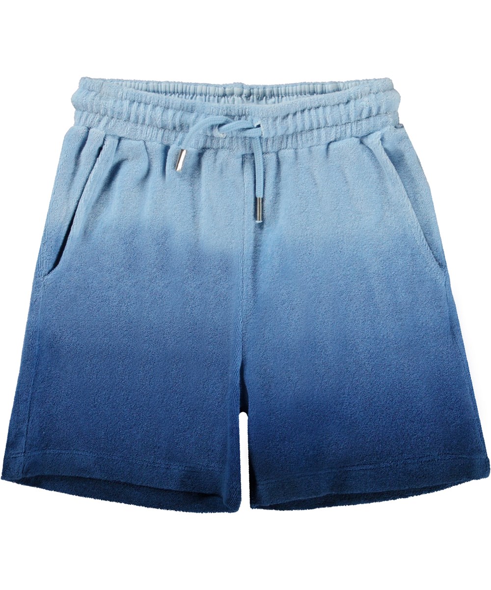 Abay - Reef Blue - Blå frottéshorts i ekologisk bomull med dip-dye effekt.