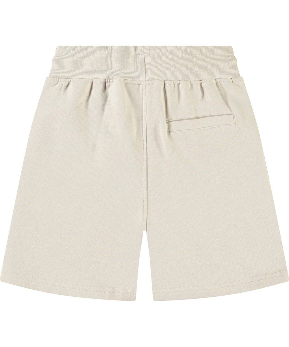 Alw - White Noise - Beige shorts i ekologisk bomull med ett grönt leende ansikte för barn.