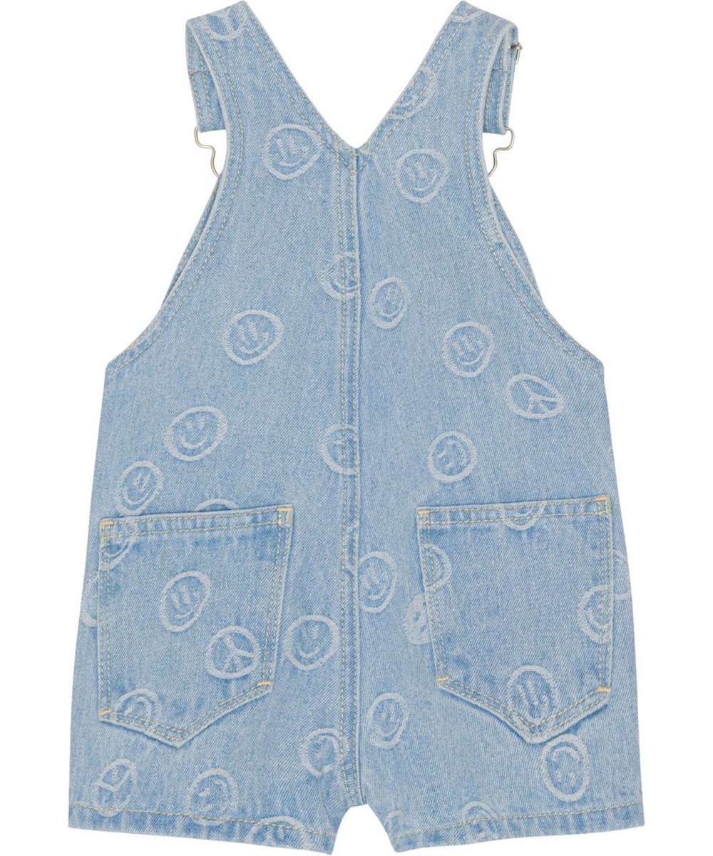 Spot - Happiness Light - Hängselbyxor i blå jeans med små invävda smileys. 