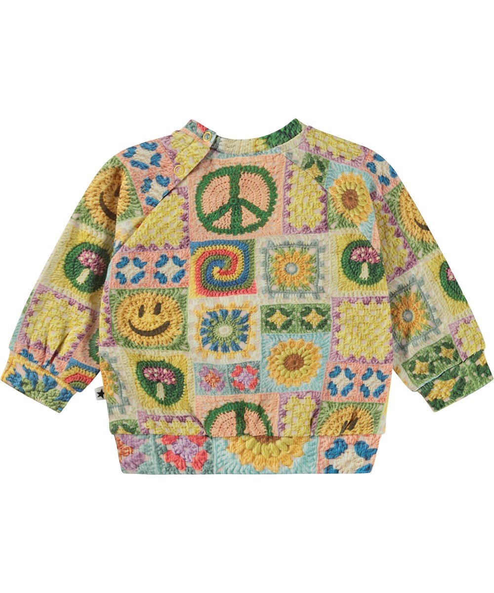 Disc - Crochet Vibe Baby - Multifärgad ekologisk babytröja med virket mönster.