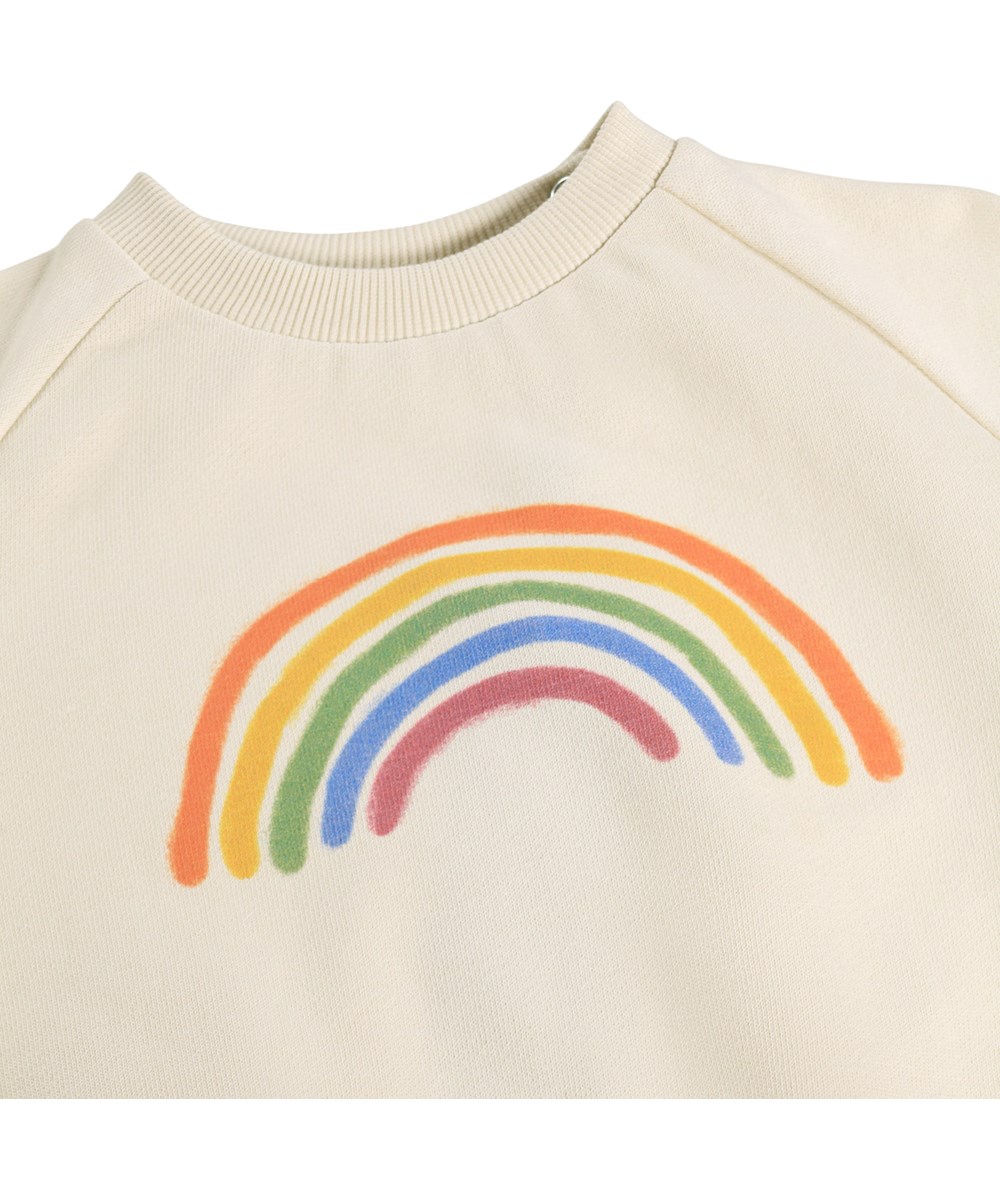 Disc - Little Rainbow - Mjuk, krämfärgad sweatshirt för de små i ekologisk bomull med ett regnbågsmönster