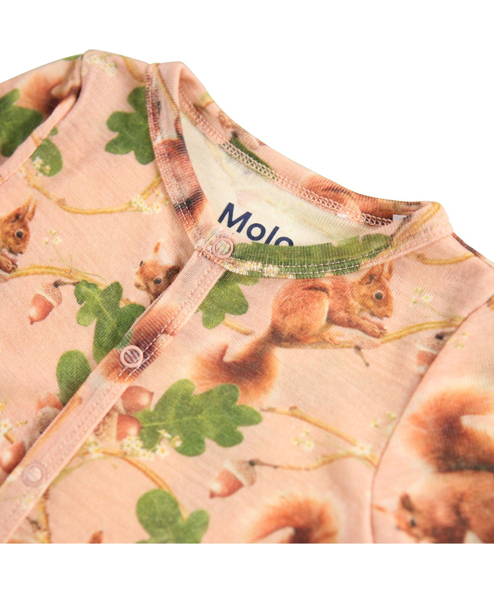 Fahari Wool - Squirrel Harmony - Rosé Baby-Strampler aus Merinowolle mit Eichhörnchen-Print.