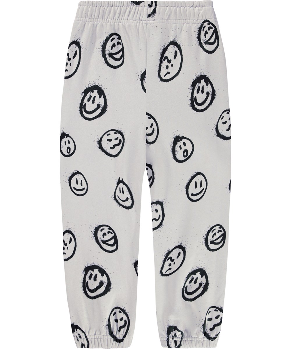 Adan - Different Moods - Gebroken witte joggingbroek voor kinderen gemaakt van biologisch katoen met een print van gezichten.