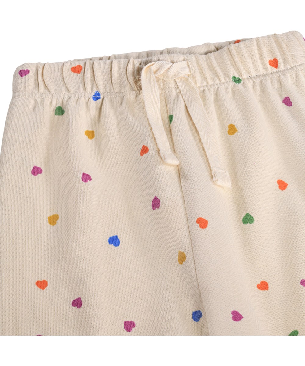 Simeon - Confetti_Rainbow - Zachte, witte joggingbroek voor de kleintjes gemaakt van biologisch katoen met een hartjesprint.
