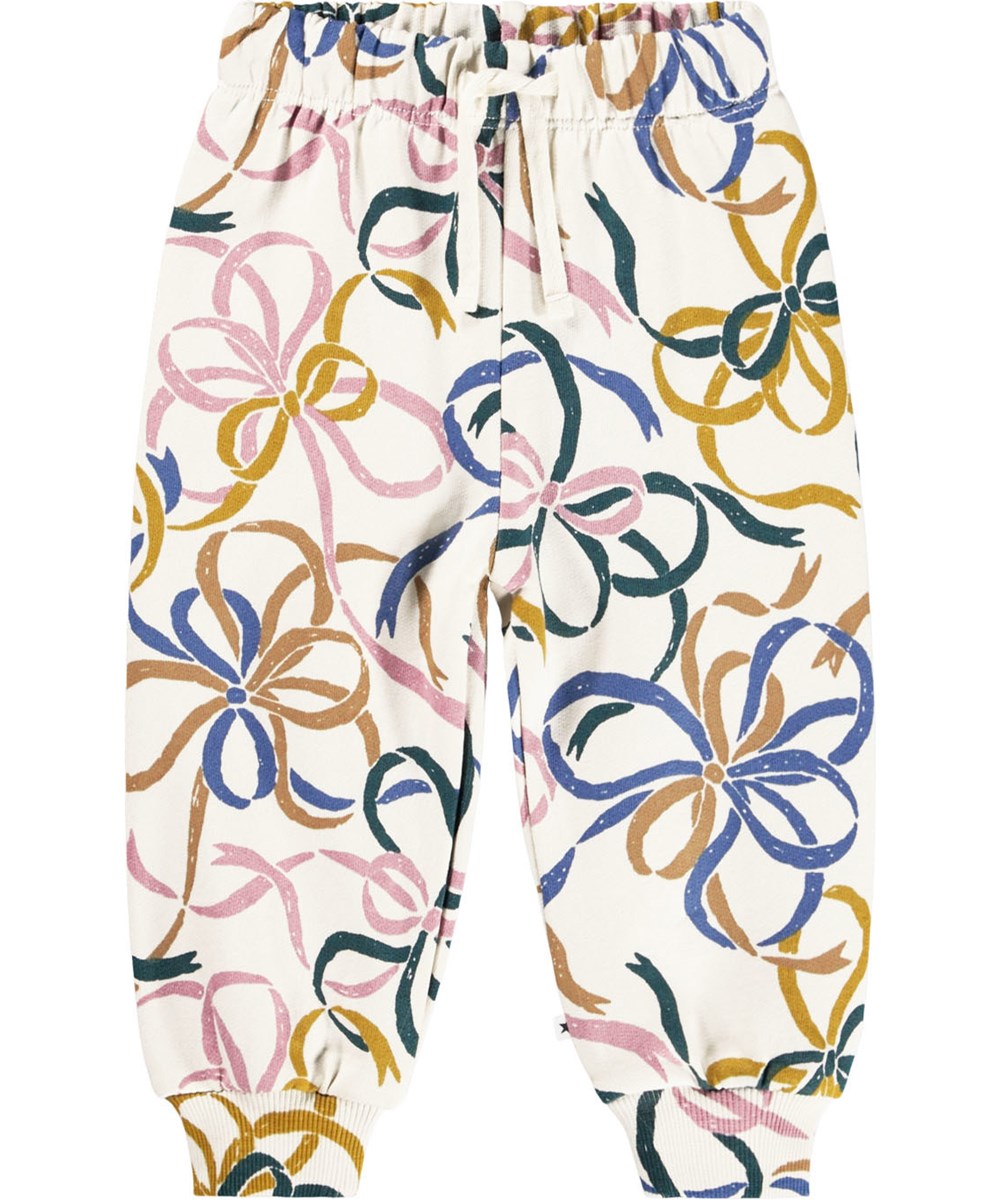 Simeon - Festivity Bows - Zachte gebroken witte broek voor de kleintjes gemaakt van biologisch katoen met een print van kleurrijke strikjes.