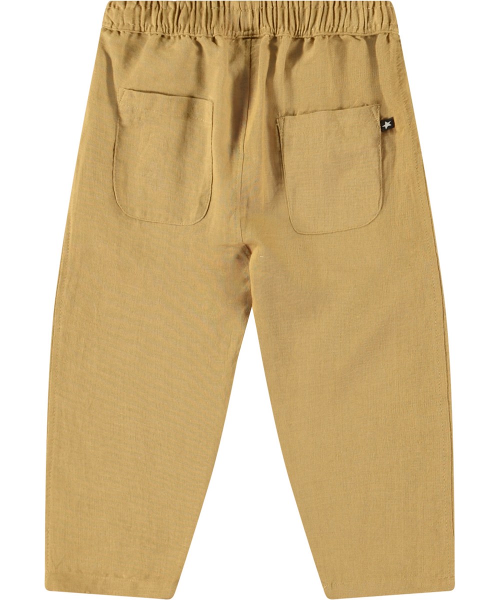 Sois - Suede - Babybroek van biologisch katoen. De broek is bruin met een kleine geborduurde smiley bij de zak.